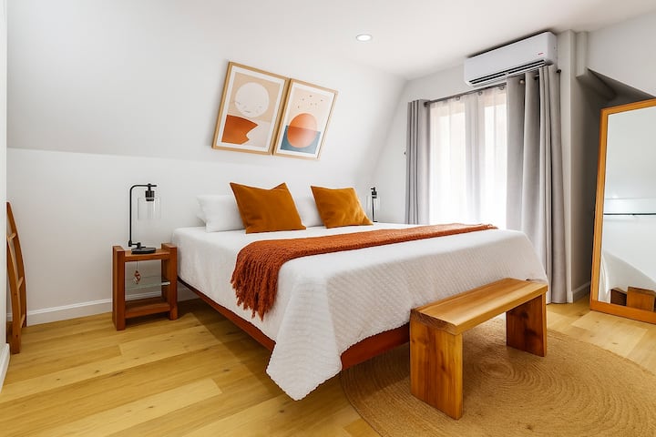 This lower-level bedroom is ideal for families. It features a generous closet, a cozy work nook perfect for quiet focus, and its own private entrance with a small porch—making it a versatile space for rest, work, or play.