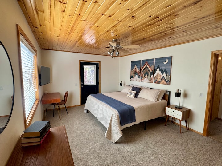 Downstairs bedroom: King bed, dedicated work space, smart TV,  and access to deck.