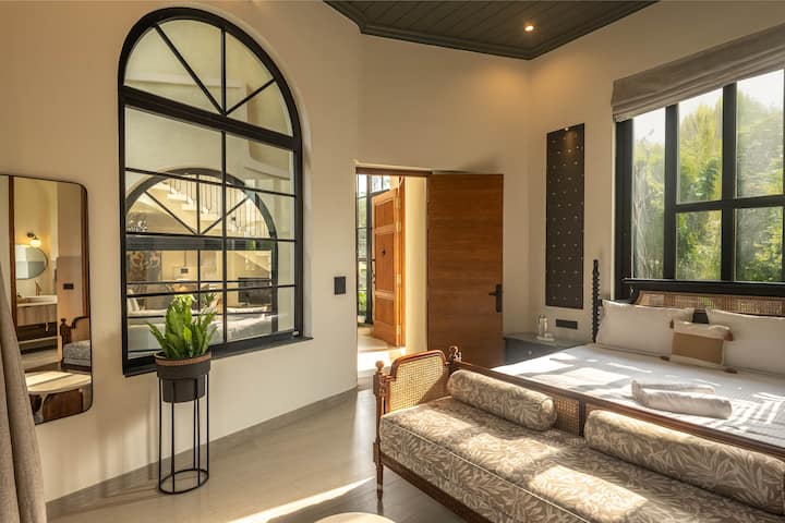 Experience restful nights in a spacious bedroom with a king-size bed, ensuite bathroom, AC, and in-room safe. Perfect for a luxurious stay in North Goa.