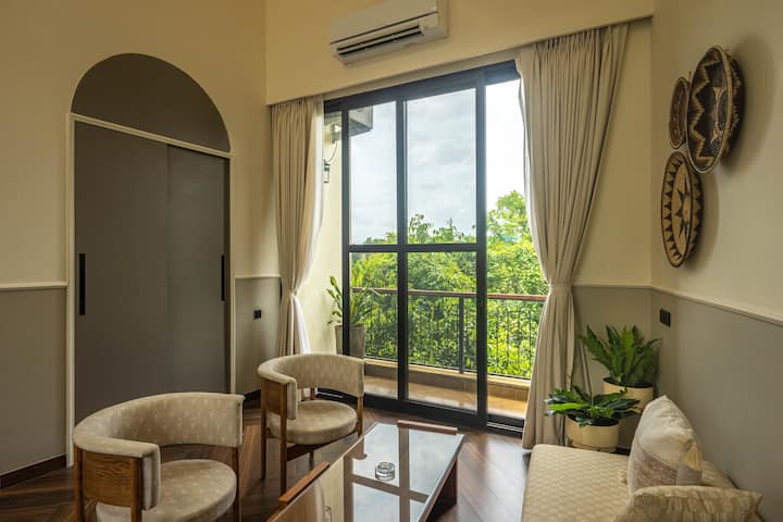 Experience restful nights in a spacious bedroom with a king-size bed, ensuite bathroom, AC, and in-room safe. Perfect for a luxurious stay in North Goa.