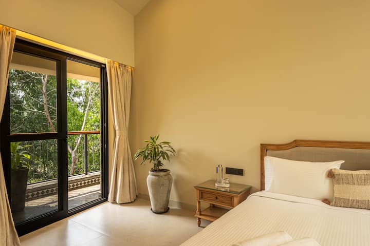 This thoughtfully designed bedroom includes a king-size bed, private ensuite bathroom, AC, and safe for a comfortable and secure stay in North Goa.