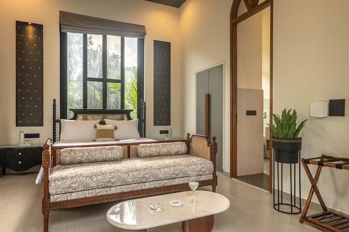 Recharge in a beautifully designed bedroom featuring a king-size bed, private ensuite bathroom, air conditioning, and a safe. Your ideal North Goa villa getaway.