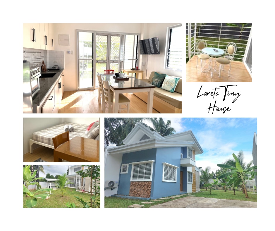 A modern kitchen features stainless steel appliances and light wood cabinetry, accompanied by a dining area set with a table and chairs. An outdoor space showcases a garden, palm trees, and a cozy patio area, alongside a two-story home with a light blue exterior.