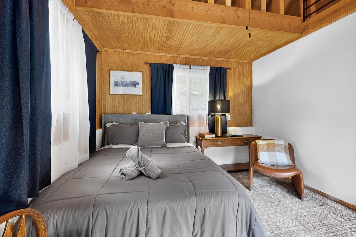A cozy cabin bedroom with warm bedding, ideal for cool mountain nights