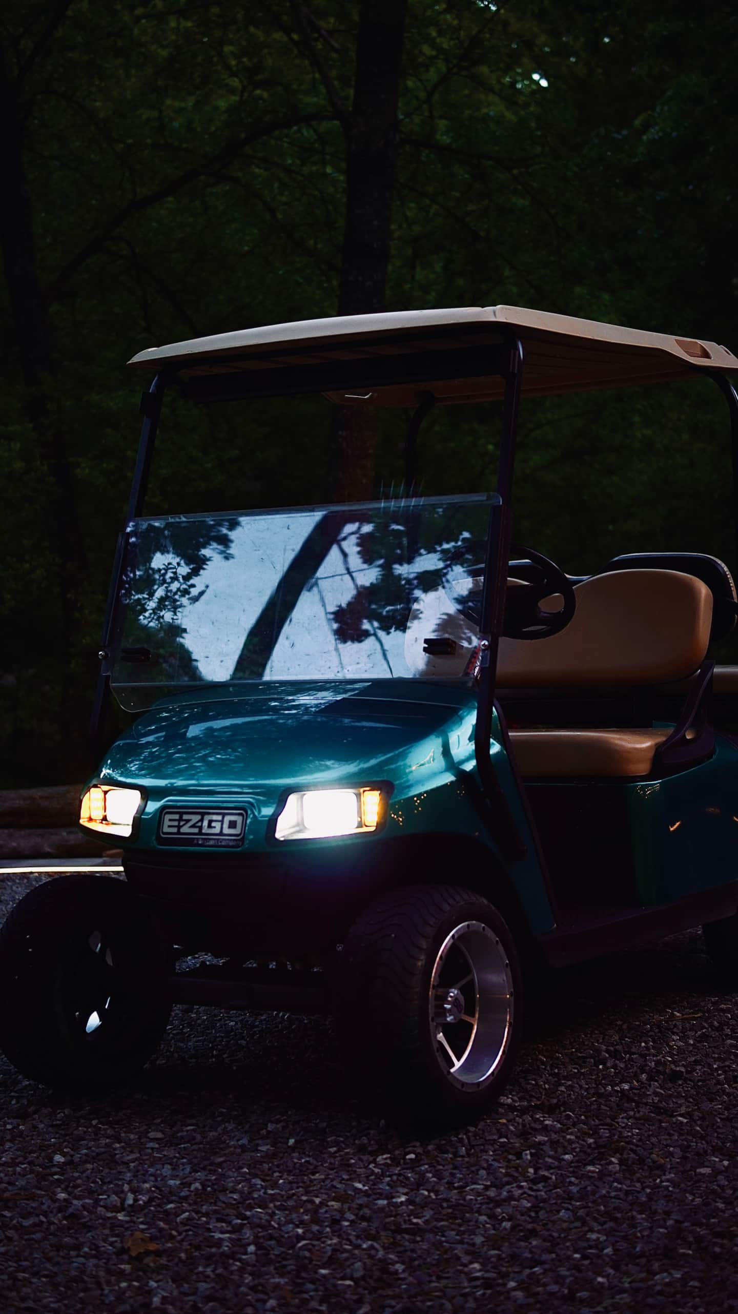 EZGO golf cart with headlights on, ready to explore the property