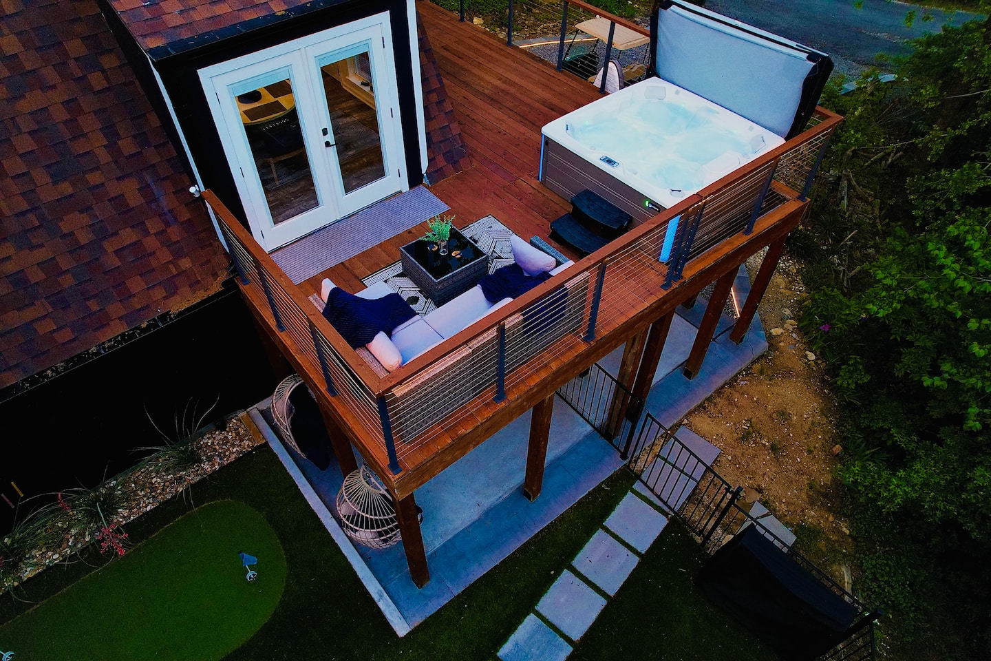 Aerial view of upper deck with hot tub and outdoor lounge seating