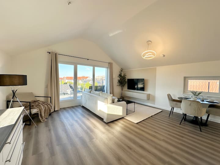 Modernes und gemütliches Wohnzimmer mit 50-Zoll-Smart-TV, gemütlicher Ess- und Leseecke, flauschigem Teppich und einer großen Terrasse!