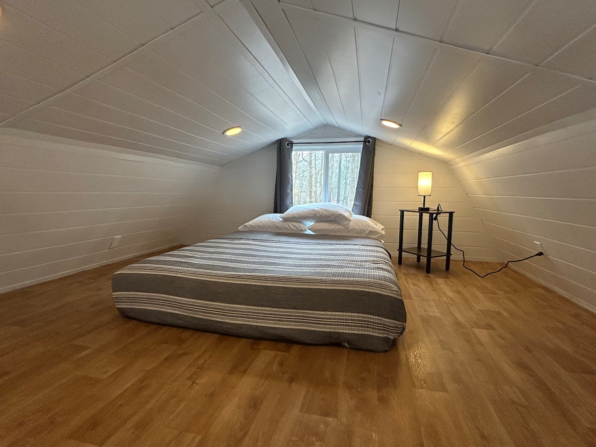 Zadné podkrovie s manželskou posteľou Queen, dostatočným priestorom na podlahu, stmievateľnými svetlami a skvelým výhľadom vonku!
