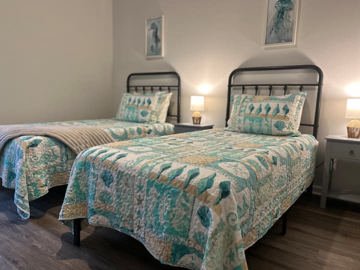 Two twin beds with comfy costal decor!
