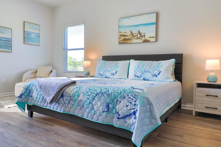 Costal decor in the master bedroom brings the serenity of the beach right to you.