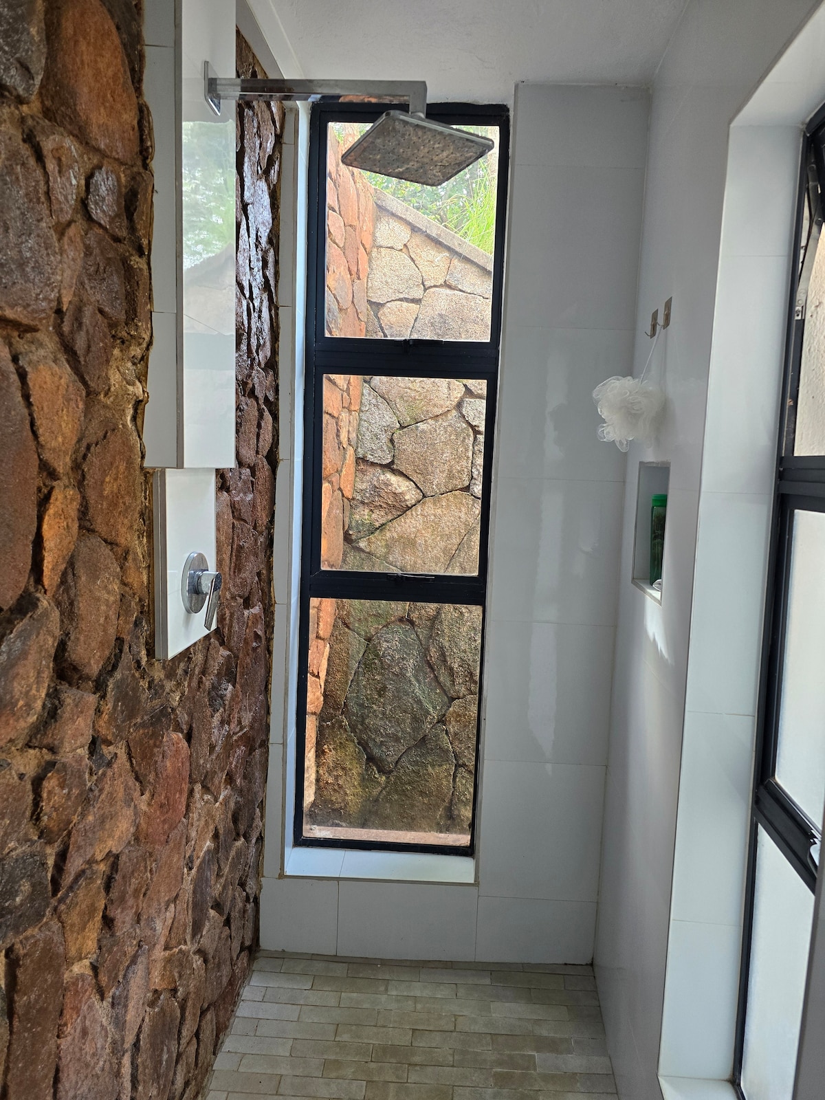 The Nest — Natural rock wall with integrated rainfall shower