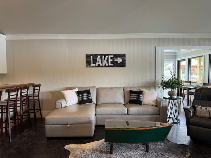 Esta sala de estar acogedora, luminosa y abierta es perfecta para relajarse y reunirse. Conecta la cocina y el comedor y cuenta con un montón de asientos, un sofá cama y un televisor ideal para relajarse después de un día en el lago o disfrutar de una acogedora noche de cine. 