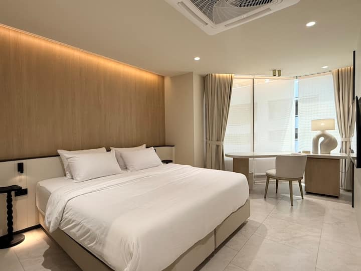 Master bedroom with a dedicated workspace situated within the room, offering a quiet and functional area for work or study.