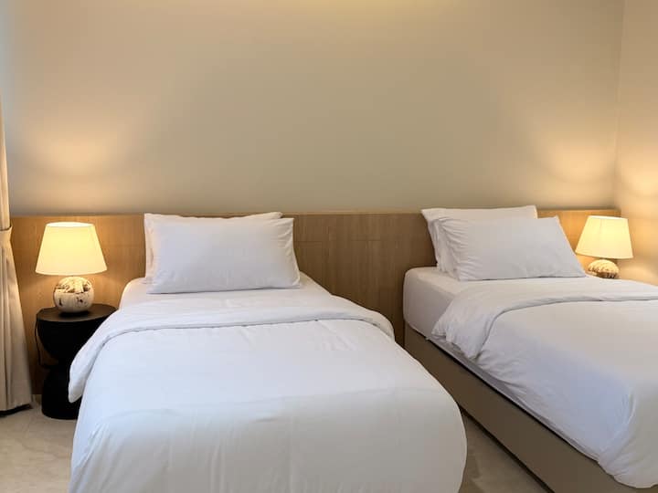 The bedroom can be set up with either two single beds or combined into a spacious king-size bed, making it perfect for a cozy stay for two. Bedrooms 2 & 3 each have private entrance. Inside, there is a connecting door that can be used optionally
