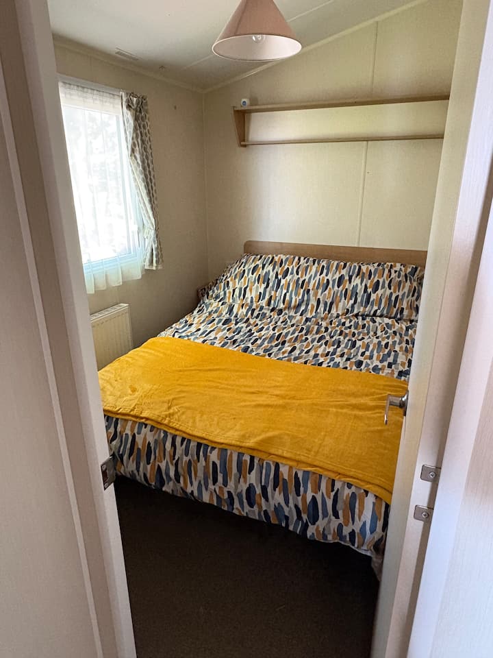 Double bed with bedside cabinets, over head storage and wardrobe 