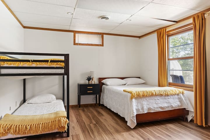 Chambre familiale avec lits superposés, lumière naturelle et touches chaleureuses