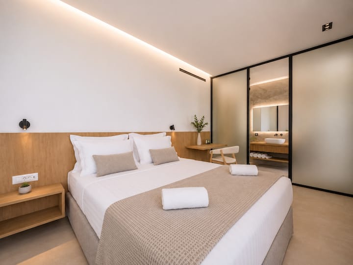 Upper Floor - Bedroom 2 – Queen-size bed, private ensuite bathroom and balcony access.