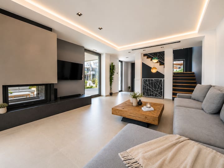Ground Floor - Bright Open-Plan Living Area – Stylish and comfortable, with fireplace, generous seating and seamless access to the private pool terrace.