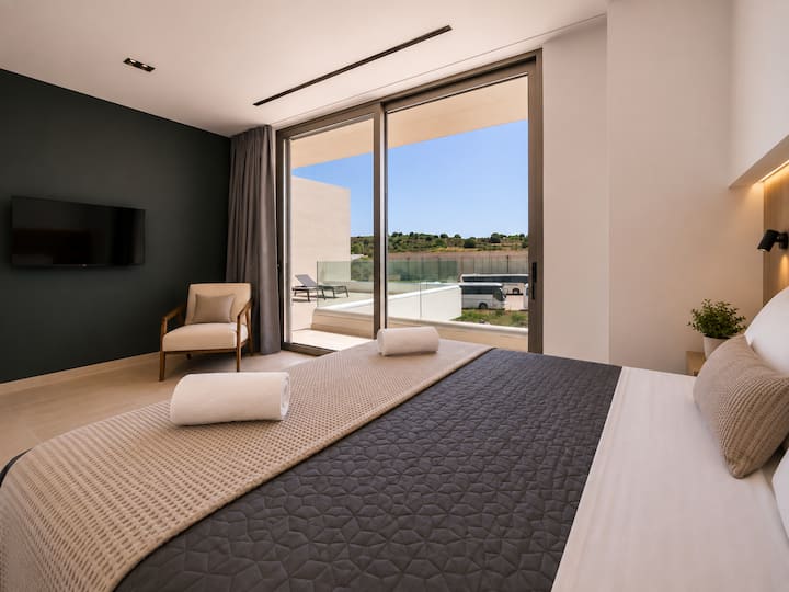 Upper Floor - Bedroom 4 – Queen-size bed, private ensuite bathroom and balcony access.