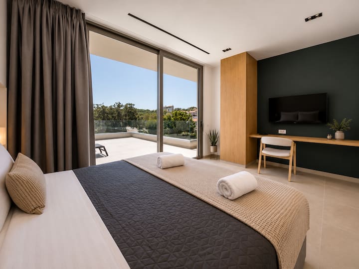 Upper Floor - Bedroom 3 – Queen-size bed, private ensuite bathroom and balcony access.