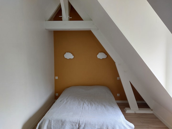 Spavaća soba na katu s bračnim krevetom i prostorom za rad