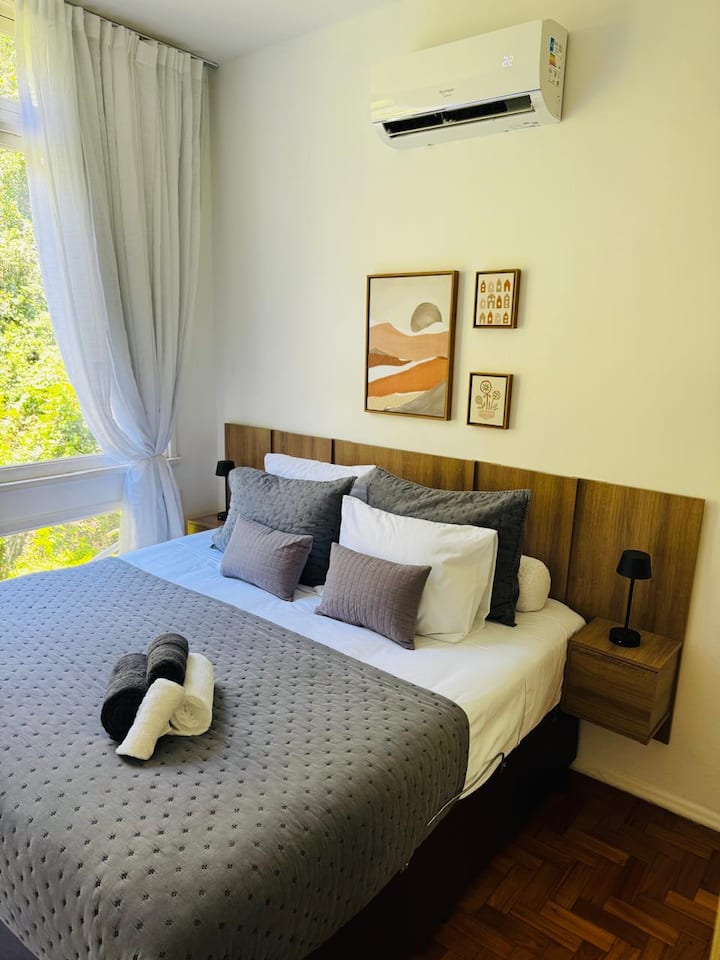 מיטת קינג סייז מרווחת ונוחה, ארון גדול עם מראה ומתלה מזוודות, נוף ירוק, עמדת עבודה, Wi-Fi ומיזוג אוויר מפוצל.