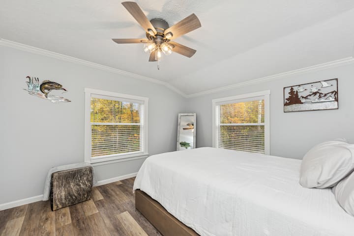 Two large windows bring in natural light and peaceful wooded views.