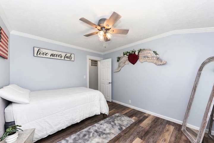 Cozy full-size bed with patriotic and love-themed décor.