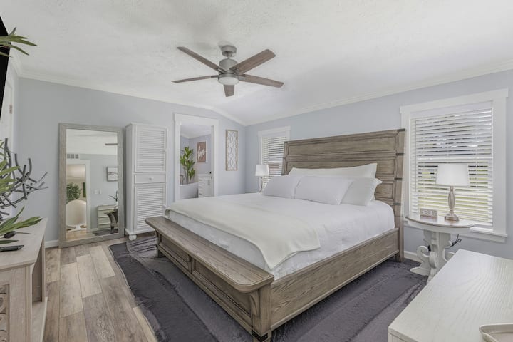 Direct access to the master bath for added comfort and privacy. 55” smart TV, ceiling fan, oversized mirror, and two spacious closets