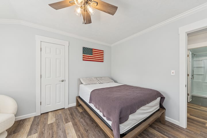 Cozy full-size bed with patriotic and love-themed décor.