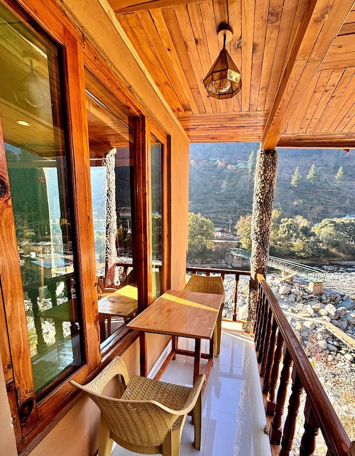 Morning tea on the balcony — the river below, the mountains ahead, nowhere to be