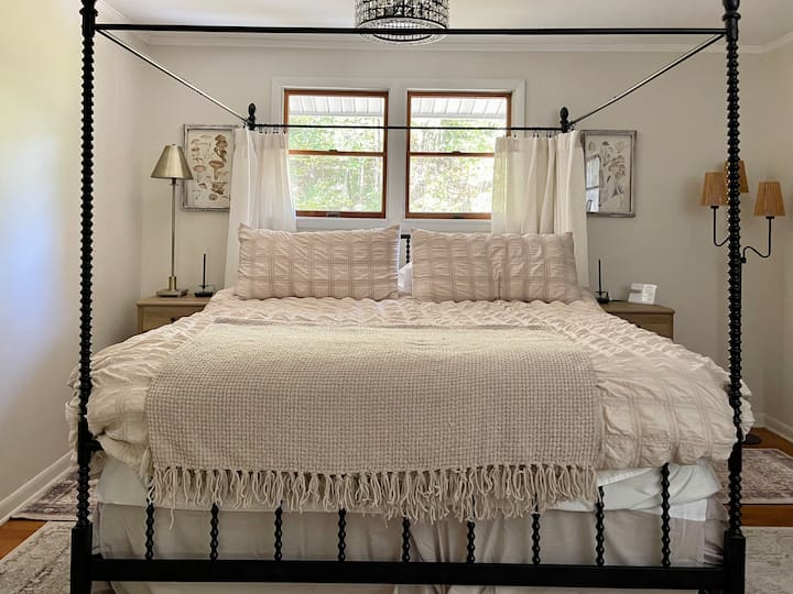 The master bedroom has a comfy king bed, attached office, private bathroom, and a brick fireplace (currently non-operational, but charming!) 