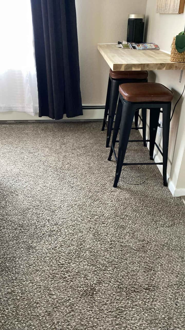 Small counter space with a couple chairs