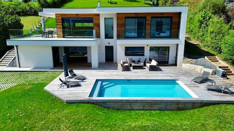 Villa with heated pool, lake view, and lake access