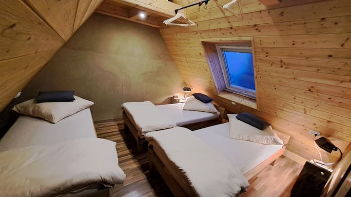 Bedroom "Nº2" with 3 single beds that can be pushed together and sockets at each bed.