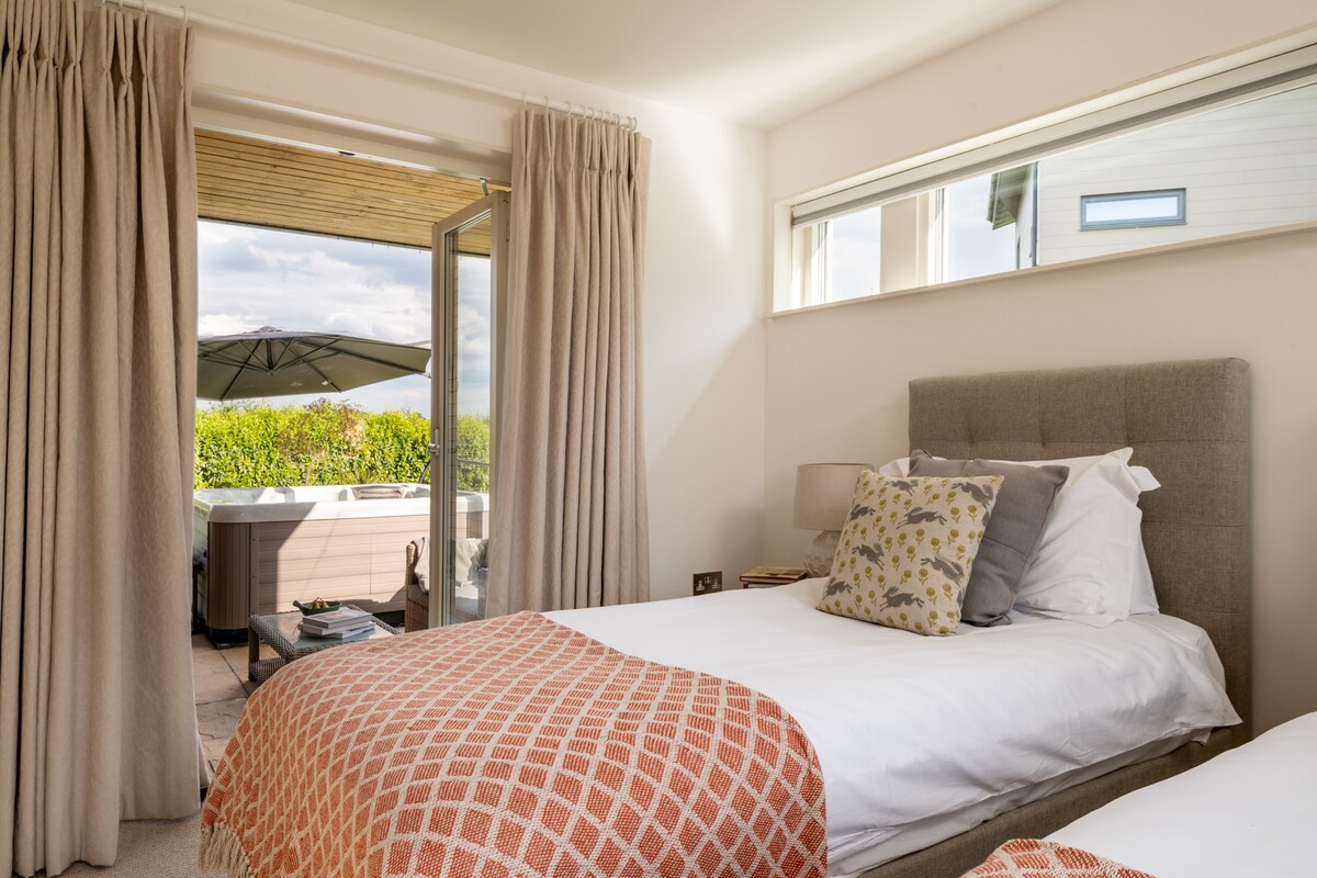 Wake up, open the doors, and let the fresh air roll in.  This bedroom can be configured as 2 singles or as a superking