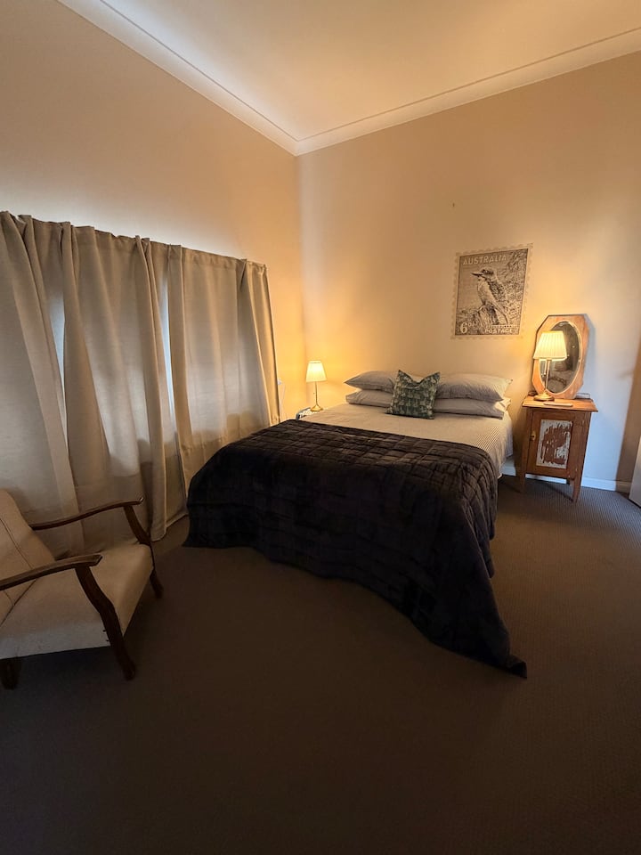 Queen size bed + bedside tables + bedside lamps + 2 mirrors + dress rack + coat hangers + bedroom chair + sheets & bedding + room darkening curtains.