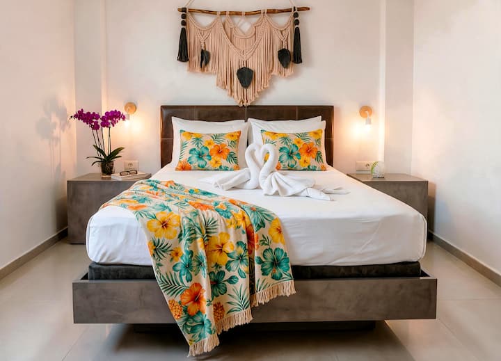 Your queen bed, made up before you even see the rest of the apartment.