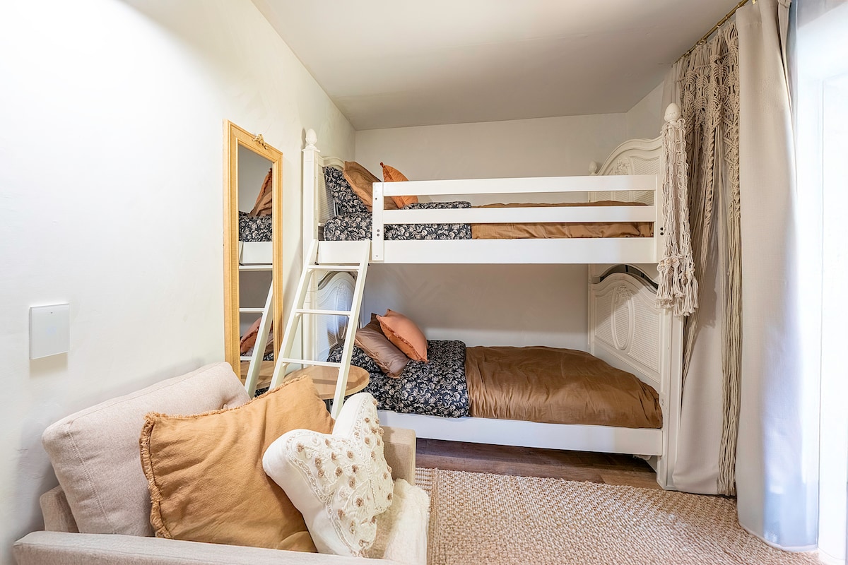 White room, 2 bunk beds, TV, electric fireplace, play area
