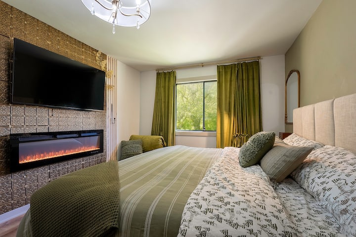 Green bedroom, king size bed, TV, electric fireplace