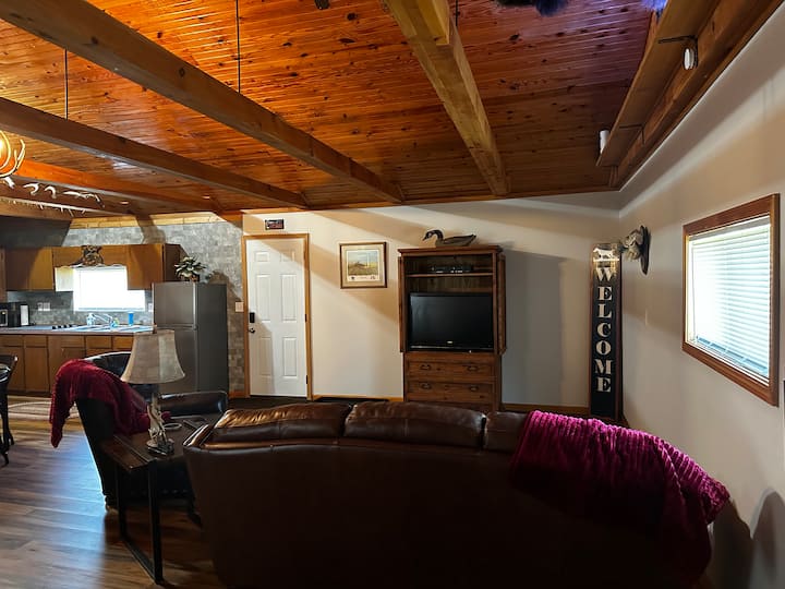 Living room furnished with 1 couch, 1 chair, television, ect. Cozy space to enjoy movies or to just hang out! We also have a DVD player and Roku TV. There is free live TV or you can log in to your streaming services to watch whatever you would like.