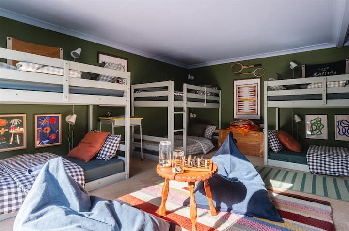 The iconic Rumpus Room! A bright, playful hideaway just for kids and teens - think nostalgic summer camp vibes with games, direct access to the secure garden and Chromecast TV. Tucked away from the main house, the rumpus room features 3 bunk beds. 