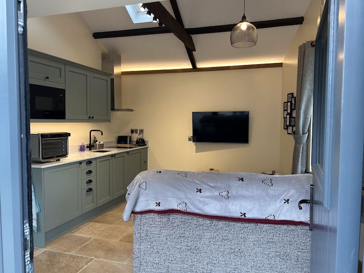 Open the front door and you'll see the cosy lounge and kitchen area.  There's space here to hang up your coats and kick off your shoes.  