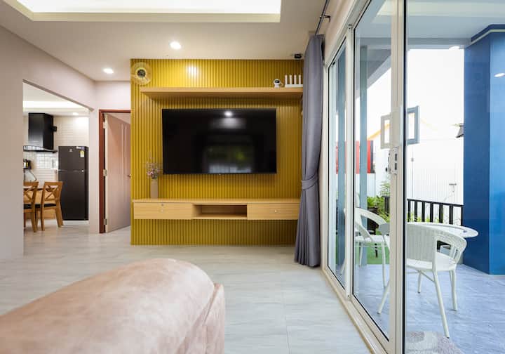 סלון מרווח עם טלוויזיה מודרנית וספה נפתחת עם מקום לשניים. 