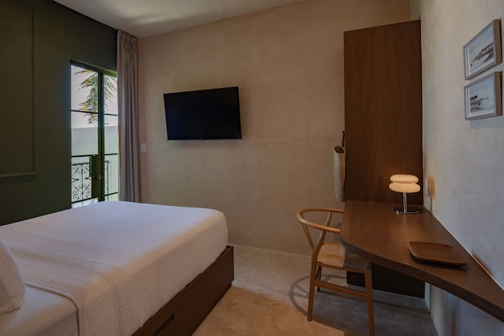 Bedroom with double bed and desk; Casa Pistache Campeche, Mexico