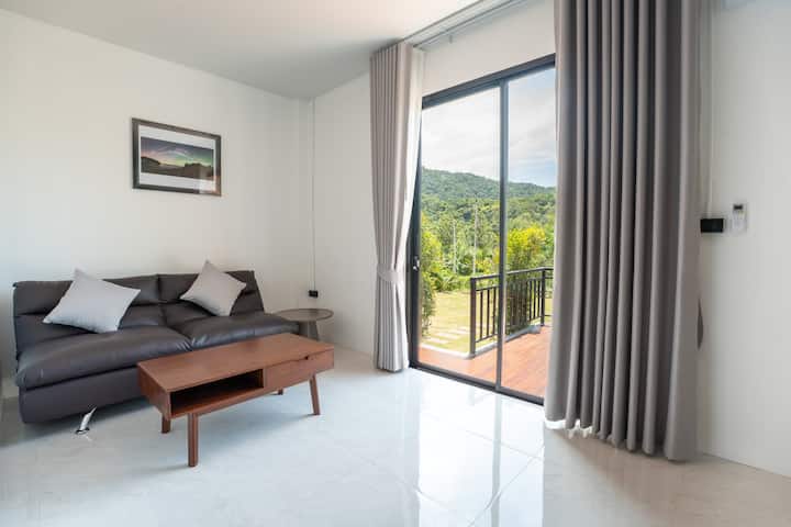 The living room sofa offering a comfortable spot with direct views of the beautiful outdoor scenery.