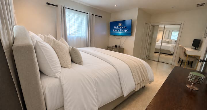 Settle into the master bedroom, featuring a king-size bed, & a dedicated office space with a desk & monitor. The bathroom offers a shower & a bright, modern design—ideal for unwinding after a day out or getting a little work done during your stay.