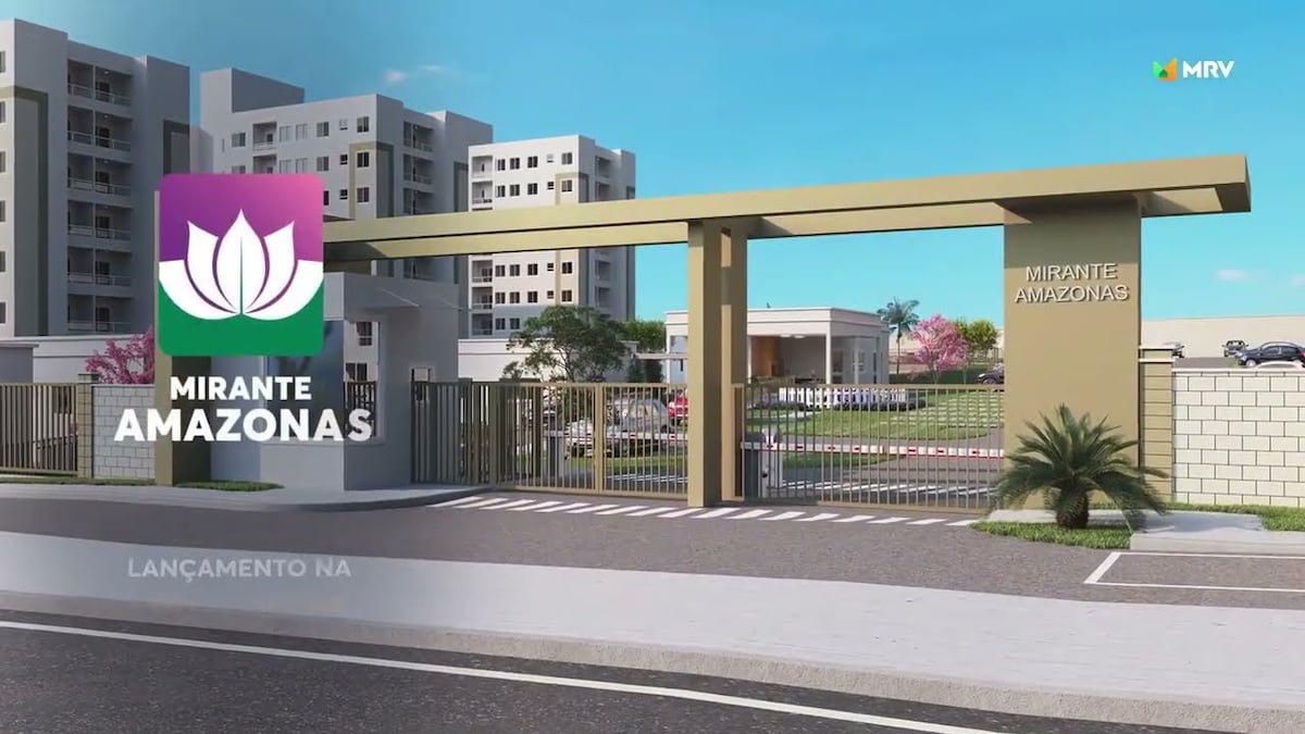 The image depicts the entrance of the Mirante Amazonas condominium. A modern gate is shown, complemented by green landscaping and a welcoming sign. Adjacent buildings display a contemporary architectural design, set against a clear sky and neat surroundings.