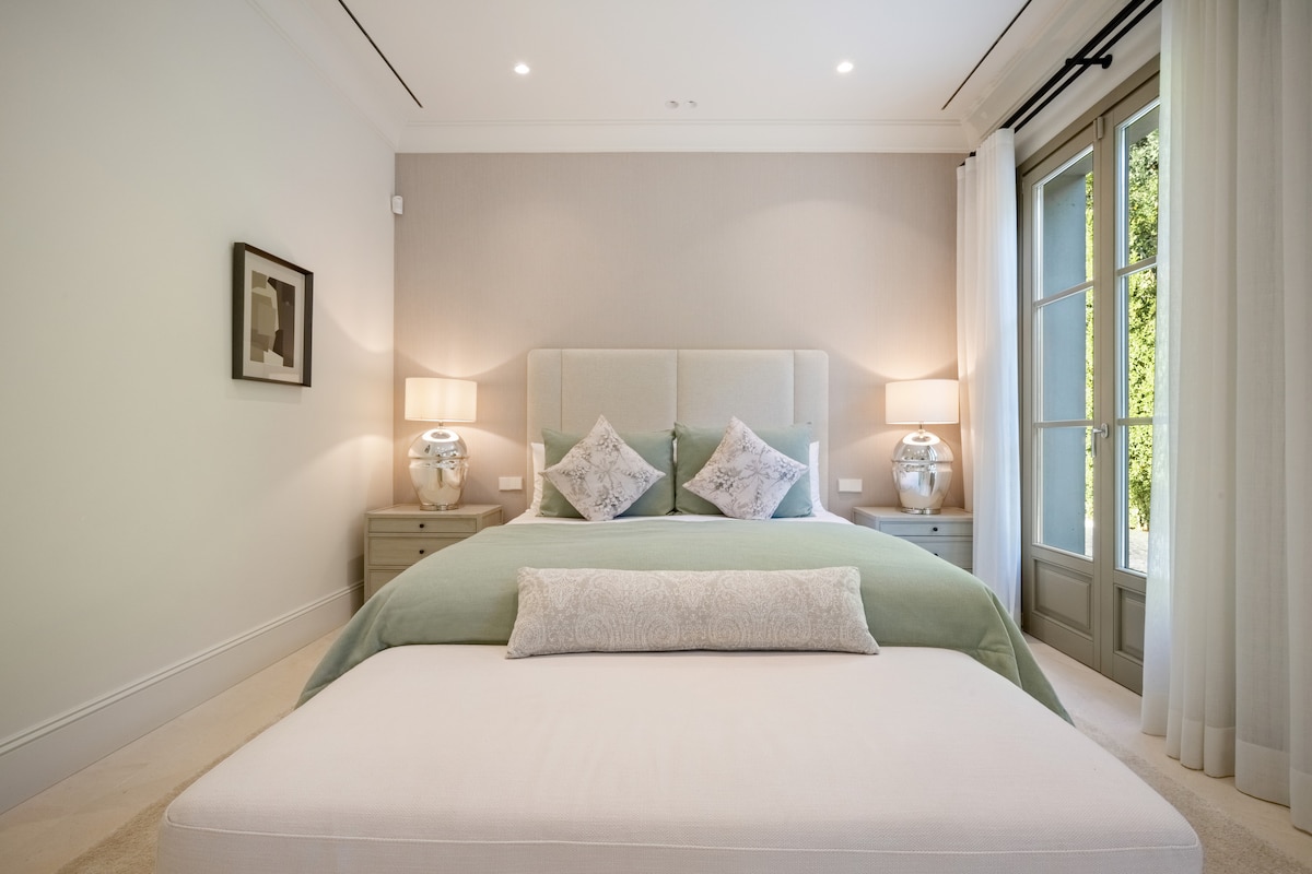 Bedroom 4 with en-suite bathroom, walk-in wardrobe, safe and access to the exterior.