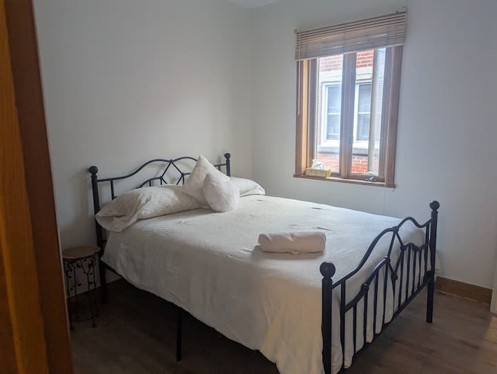 This welcoming second bedroom features a double bed and a large closet